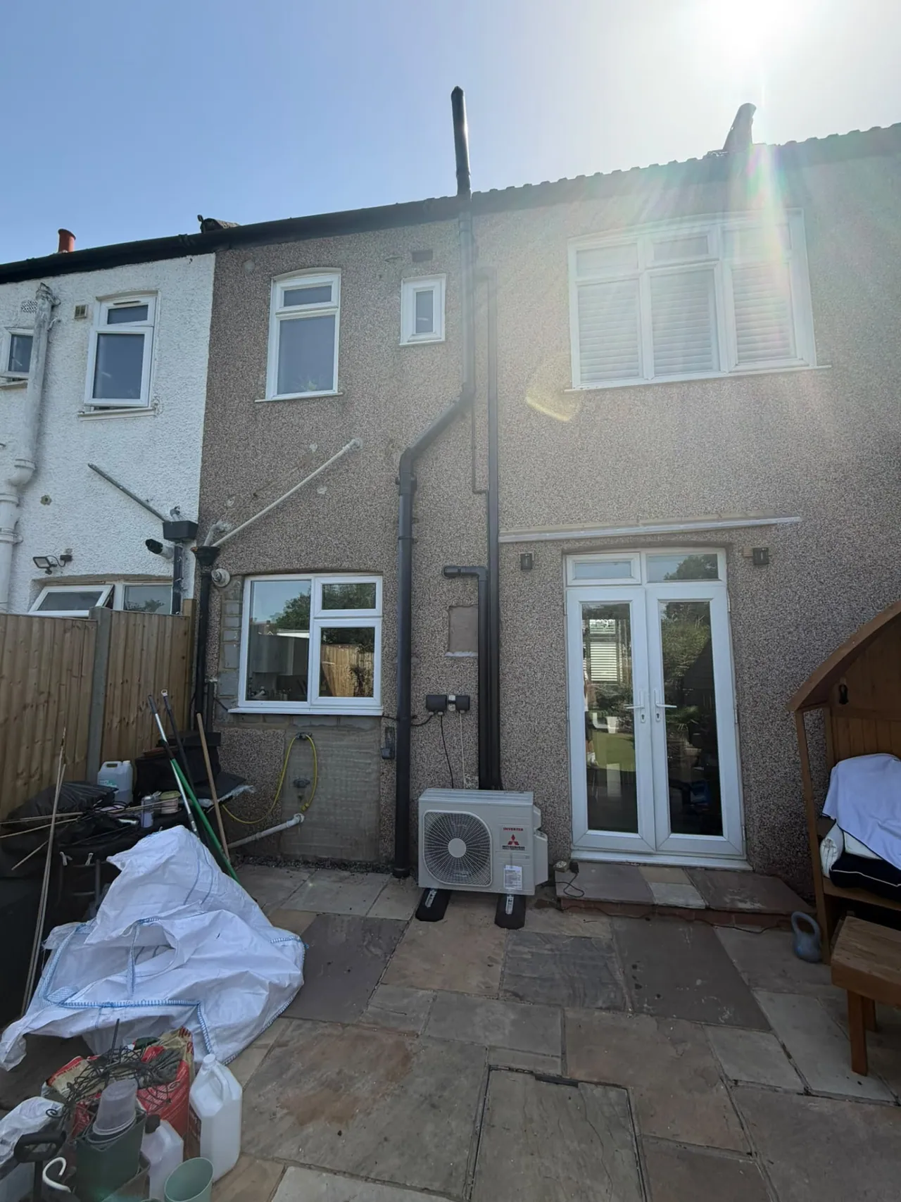 Mitsubishi air conditioning outdoor condenser installed on a rear patio of a terrace