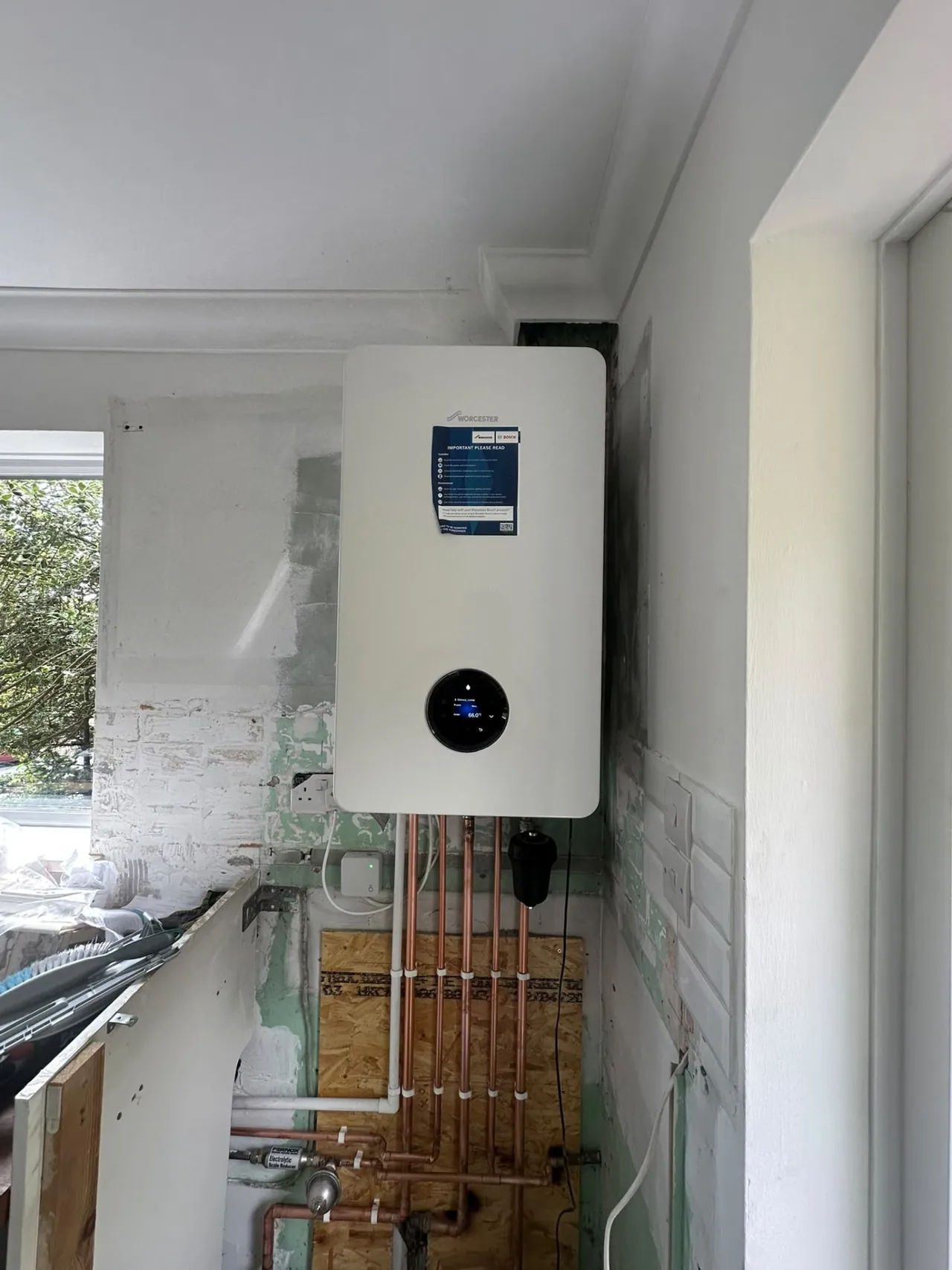 Worcester Bosch boiler with copper pipework in a utility area