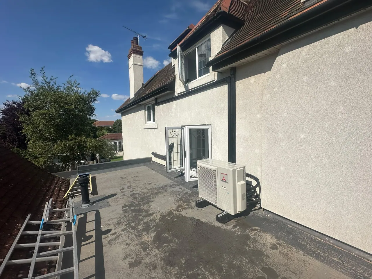 Mitsubishi air conditioning outdoor condenser installed on a flat roof