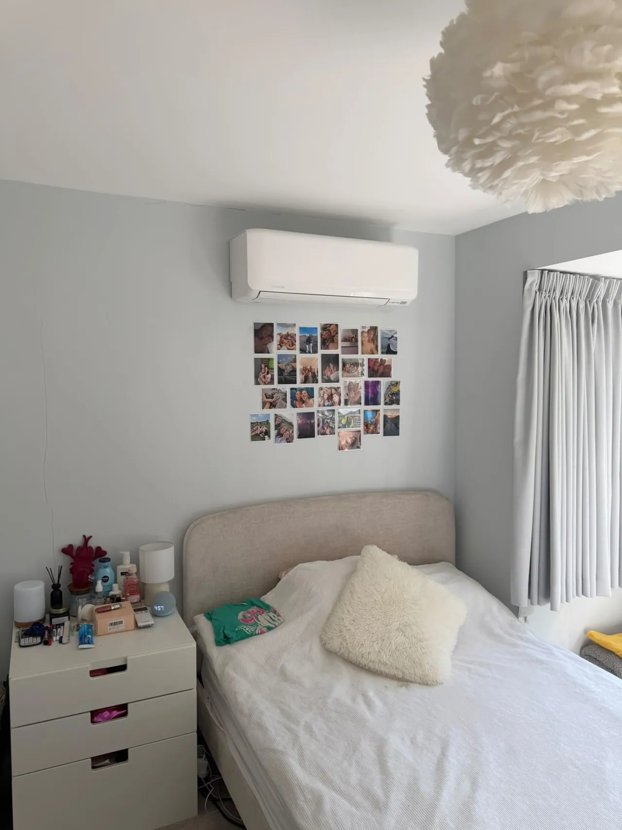 Wall-mounted air conditioning unit installed above a bed