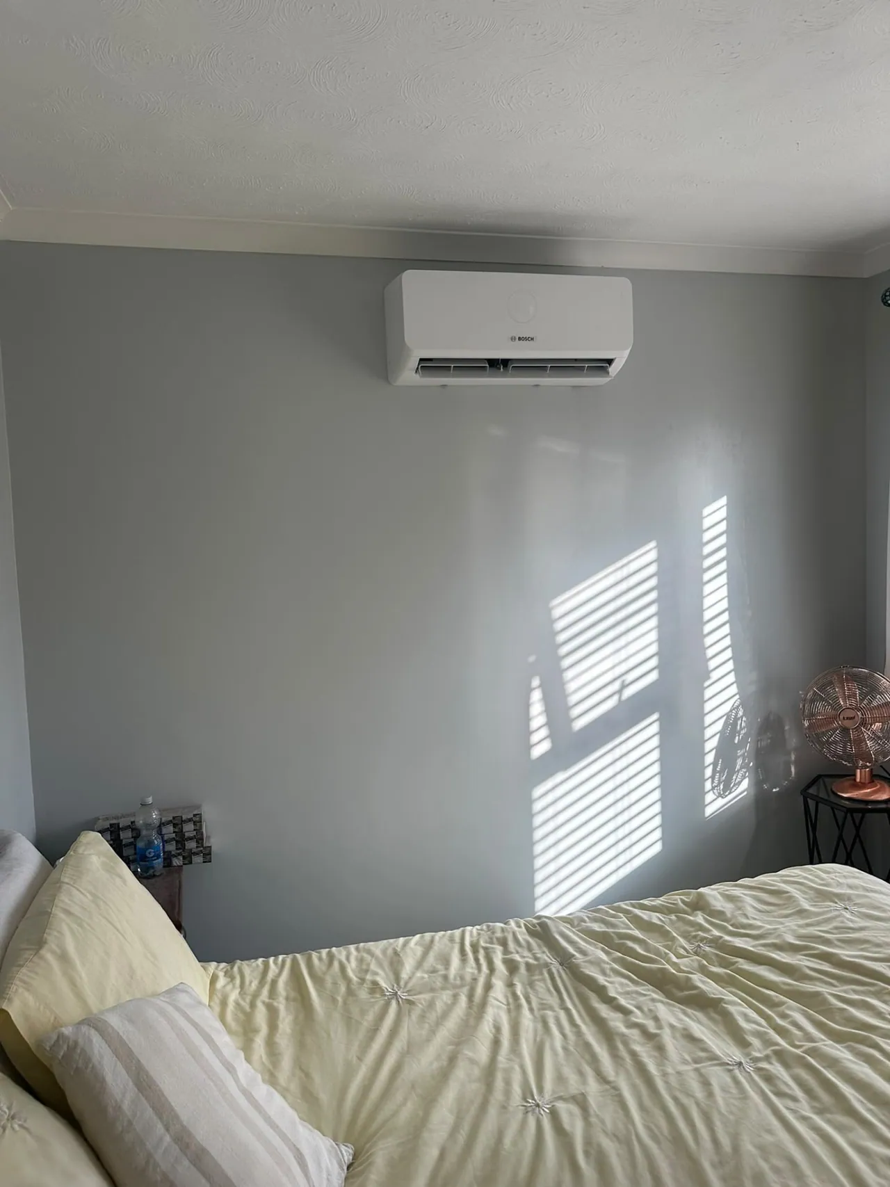 Bosch wall-mounted air conditioning in a sunny bedroom