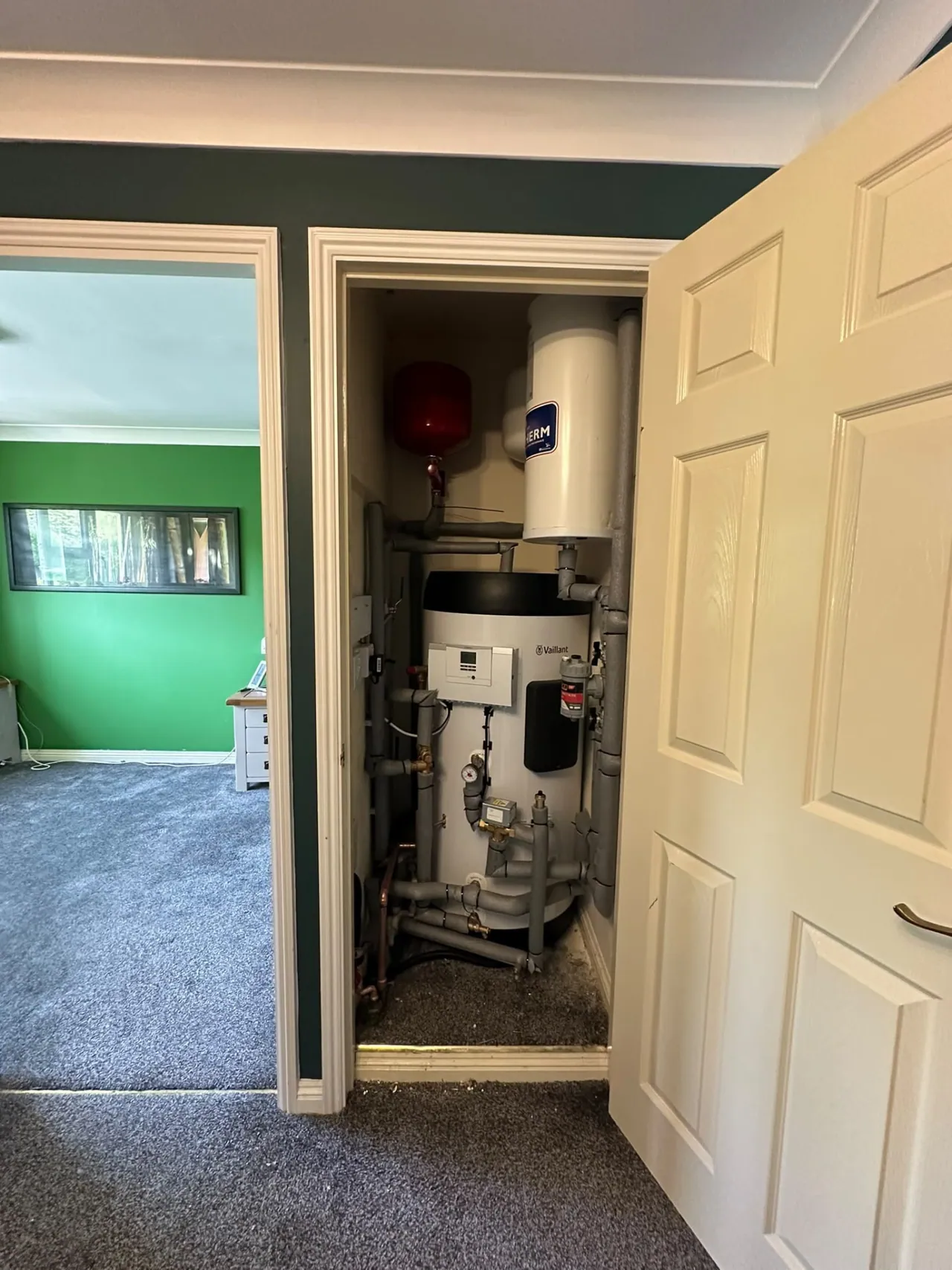 Vaillant heat pump cylinder system installed in a hallway cupboard