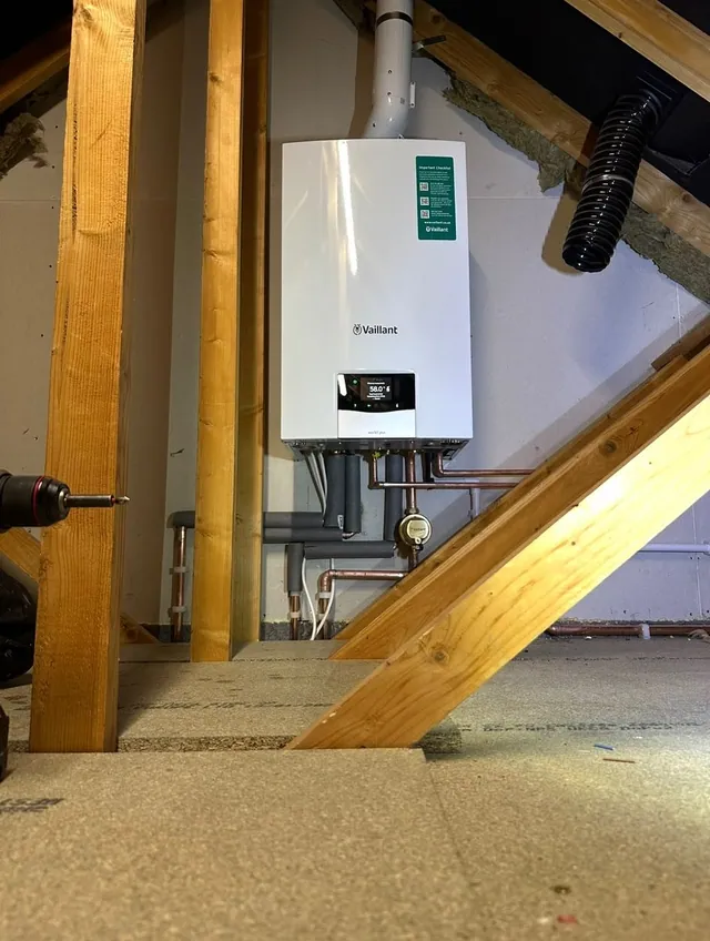 Vaillant boiler installed between loft rafters with insulated pipework