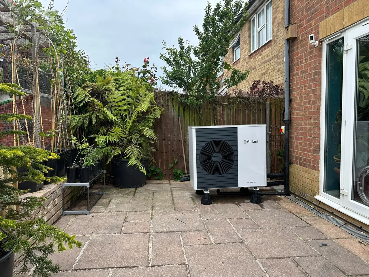 Vaillant air source heat pump outdoor unit installed beside a house